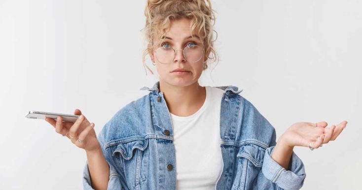 awkward-unsure-clueless-cute-clumsy-european-blond-female-assistant-wear-glasses-messy-bun-smirking-unsure-spread-hands-sideways-unaware-holding-smartphone-sure-how-solve-problem